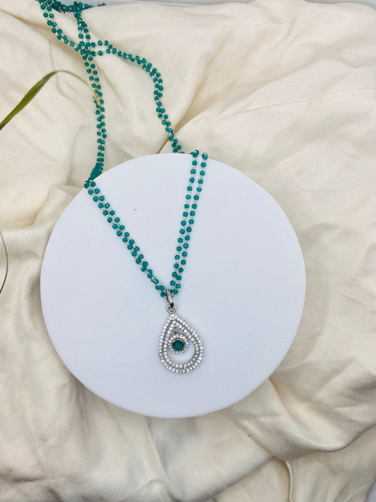 Teardrop Pendant Necklace,paired with a double-strand green pearl chain.